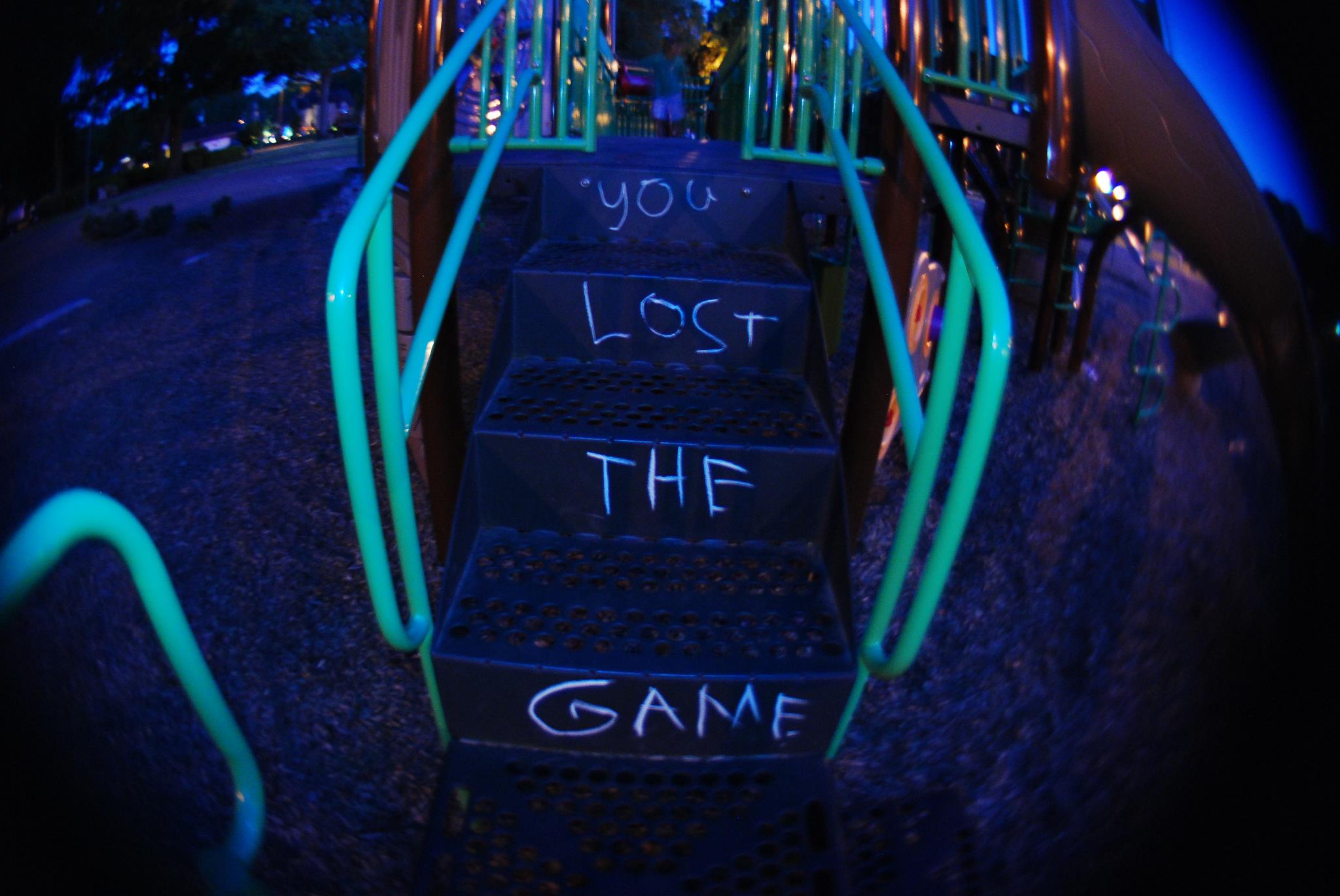 a staircase with "you lost the game" written in chalk on it